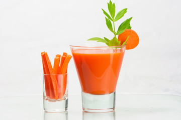 glass of Fresh organic carrot juice .