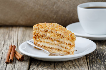 Tasty honey cake on wooden background.
