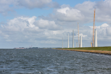Dutch construction site building wind turbines seen from the sea