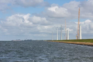 Fototapete Mühlen Dutch construction site building wind turbines seen from the sea