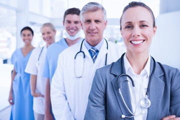 Smiling team of doctors standing in line