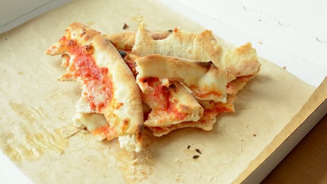 pizza leftovers accumulate in pizza box - timelapse - closeup