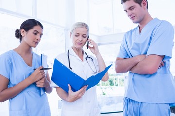 Team of doctors looking at folder