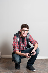 teenage boy using a handheld tablet