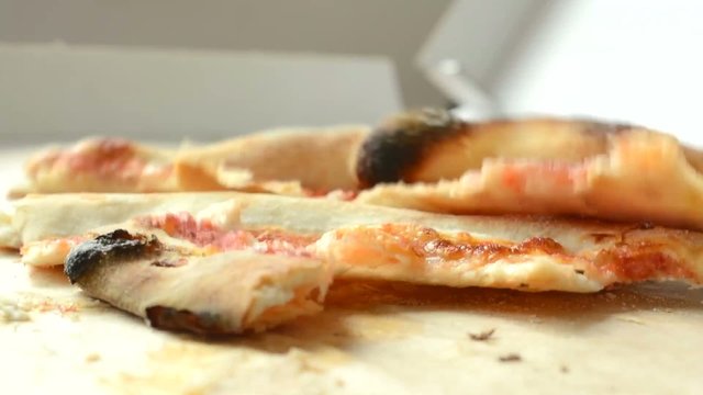 pizza leftovers accumulate in pizza box - closeup