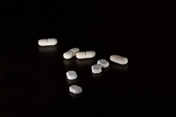 Drugs: Pills and Tablets on dark background