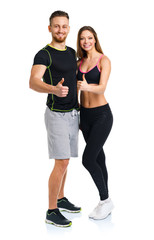 Athletic man and woman after fitness exercise with thumbs up on