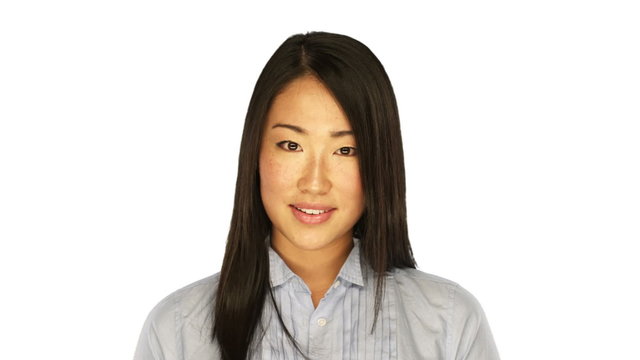 Asian Woman smiles into the camera on a white background