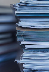 Accounting and taxes. Large pile of magazine and books