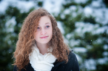 teenage girl with long curly hair outdoors in the winter weather