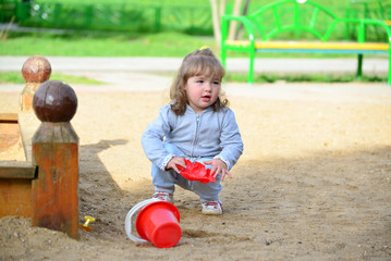 Little girl playing in the sandbox