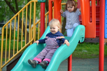 Fototapeta na wymiar Two little girls playing on playground