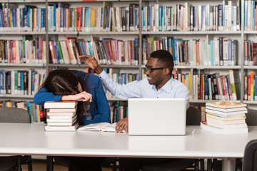 Female Student Sleeping In Library