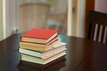 books  stacked up on a table