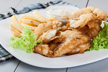 Fish and chips with tartar sauce on a plate