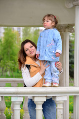 Fototapeta premium Mom and daughter 2.5 years for a walk in gazebo