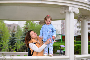 Mom and daughter 2.5 years for a walk in  gazebo