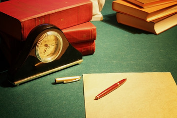work desk clock pen book paper
