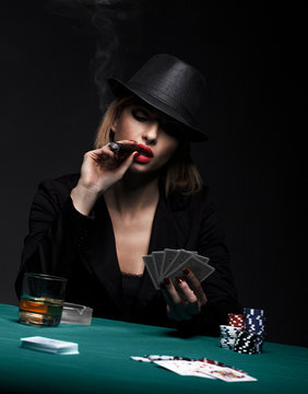 Beautiful young woman playing poker