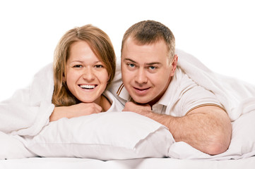 Obraz na płótnie Canvas Couple lying in bed smiling