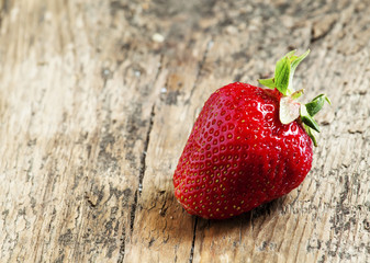 Fresh strawberries on a wooden table in rustic style, selective