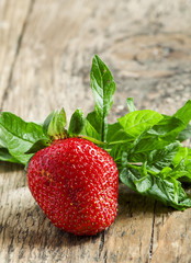 Fresh strawberries on a wooden table in rustic style, selective