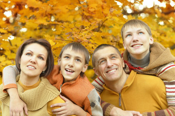  Family relaxing in autumn park