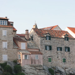 Fototapeta na wymiar Old traditional houses built on a cliff. In Split Croatia. 
