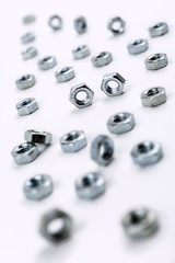 Collection of Bolt Nuts In A White Box - Crooked Angle