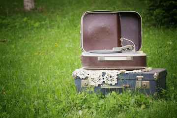 Vintage suitcase player on nature