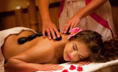 Obraz na płótnie Canvas Healthy Spa: Young Beautiful Relaxing Woman Having Stone Massage