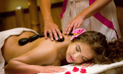 Obraz na płótnie Canvas Healthy Spa: Young Beautiful Relaxing Woman Having Stone Massage