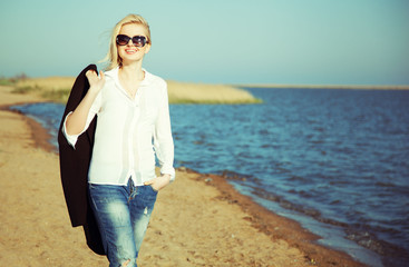 Happy young woman enjoying sun and good weather at the sea.
