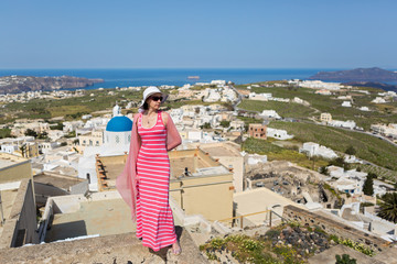 Obraz premium Woman in a long dress,Santorini, Greece.