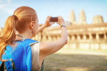 Tourist taking picture of the Angkor Wat temple in Cambodia