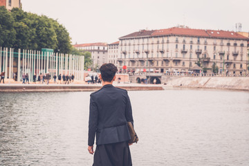 Handsome Asian model posing by an artificial basin