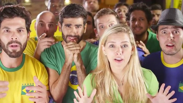Brazilian Fans Watch a Soccer Game at a Sports Bar