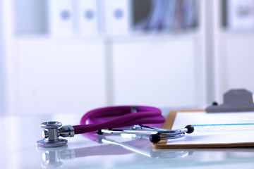 Doctor&amp;#39;s stethoscope  with folder on the desk
