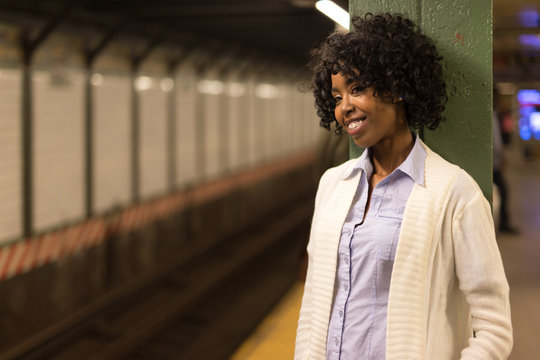 Young African American Black Woman In City At Night Waiting Subway Train