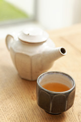 kettle and tea cup on table