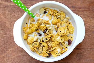 cereal made from cornflakes and caramel topped milk on wooden