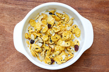 cereal made from cornflakes and caramel topped milk on wooden