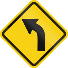 Colombian road warning sign: Left curve ahead