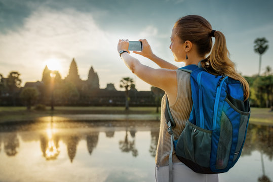 Tourist taking picture of the mysterious Angkor Wat, Cambodia