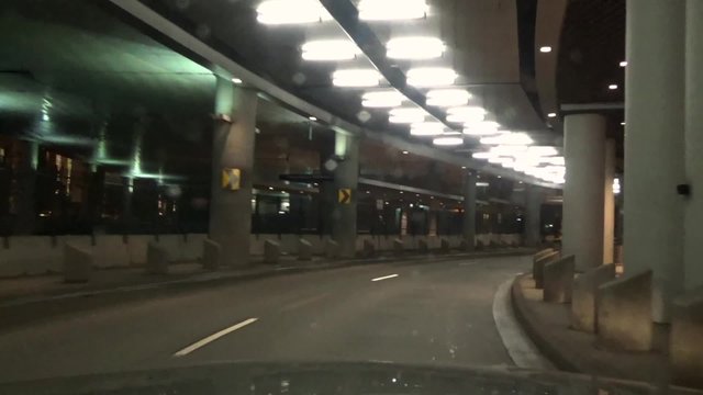 Time lapse of a brightly lit underpass at night
