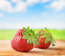 Fresh ripe strawberries on  wooden board