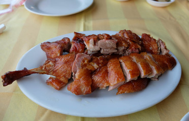 Roasted duck leg  sliced portions on plate, Chinese cuisine