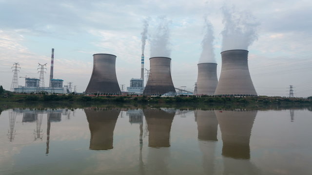 thermal power plant ,cooling towers and reflection  ,time lapse