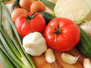 Composition of vegetables and greens lying on the table