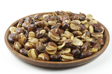 Broad bean in wooden dish on isolated white